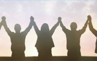 silhouette of people holding hands in a long chain